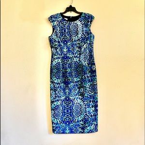 Blue floral with leather like neckline trim.